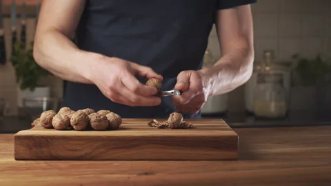 Shelling Walnuts with a Nutcracker Stock Footage 243936830