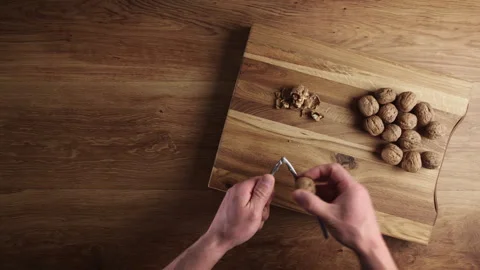 Shelling Walnuts with a Nutcracker Stock Footage 243936898