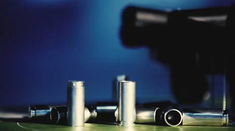 Shells and pistols on a blue background close up Stock Footage 54620279