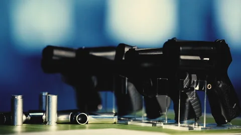 Shells and pistols on a blue background Stock Footage 54620282