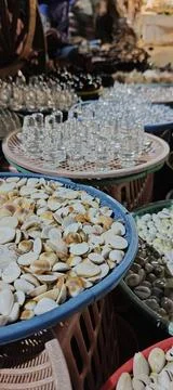 Shells and Shivling on a table for selling Stock Photos