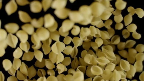 Shells pasta flies being exploded. Italian pasta macaroni before preparation Stock Footage 105855421