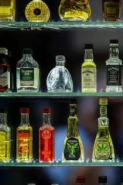 Shelves with assorted small bottles possibly containing alcohol or spirits Fotos de archivo