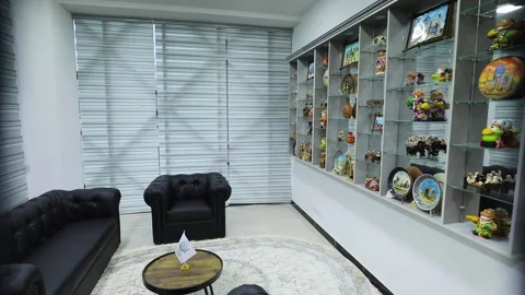 Shelves, black armchairs and sofas. White room with blinds. Pan around Stock Footage 162117079