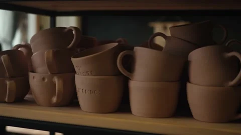 Shelves with ceramic dishware in pottery workshop Stock Footage 157992487
