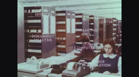 Shelves with data tapes and employee working on tax returns Stock Footage
