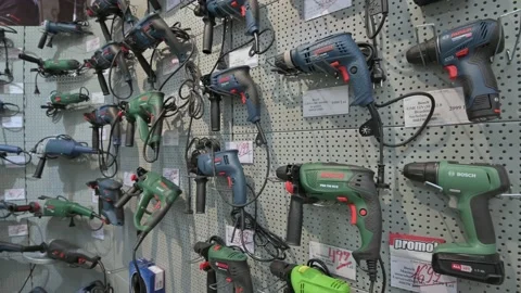 Shelves in a DIY shop with variety of power tools, mostly from the Bosch brand Stock Footage 139014423