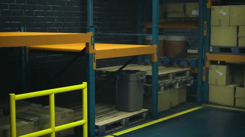 Shelves filled with boxes and a trash can in a dimly lit warehouse Stock Footage 341831298