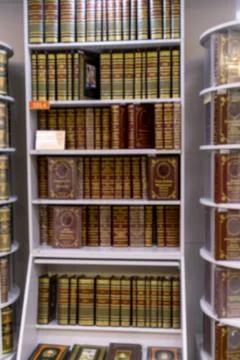 Shelves filled with richly decorated leather-bound books in bookstore. Clas.. Stock Photos