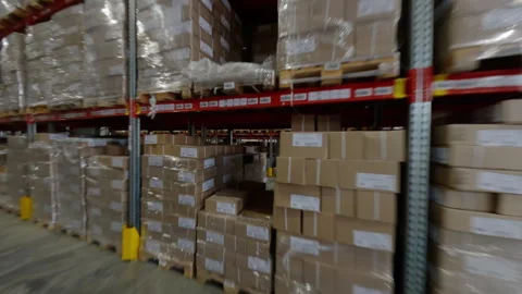 Shelves packed with cardboard boxes define warehouse interior Stock Footage 290670380