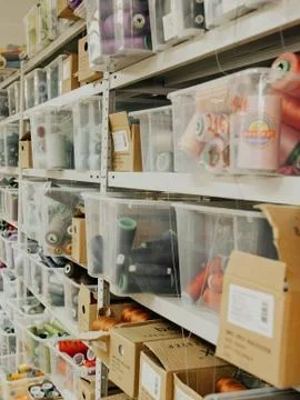 Shelves with spools of colored thread Stock Photos