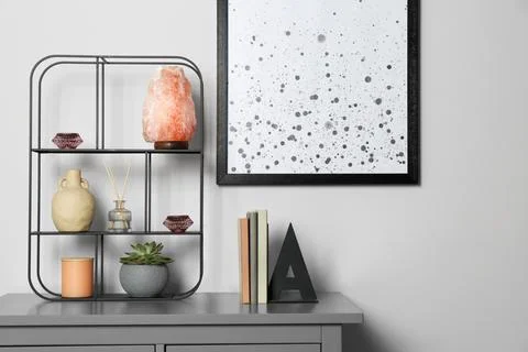 Shelving unit with decorative elements on chest of drawers. Interior design Stock Photos