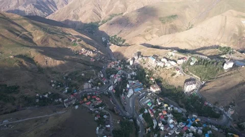 Shem mountain village sits in a deep valley under brown peaks, an aerial look Stock Footage 343804005