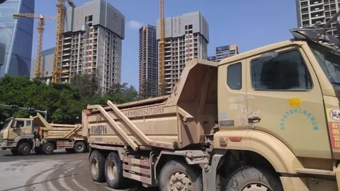 Shenzhen, China: Large trucks loading construction soil on Yueliangwan Avenue Video stock 251313819
