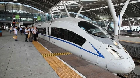Shenzhen/China circa 2016: passengers boarding high speed electric train. Stock Footage