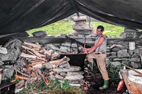 Shepherd making cheese in the Alps Stock Photos