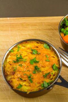 Shepherds or cottage pie in serving dish with parsley, portrait, macro Stock Photos