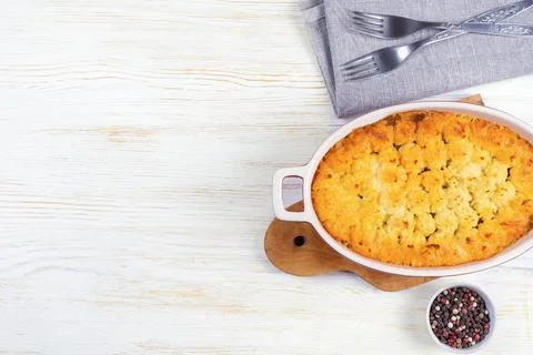 Shepherd's Pie or Cottage Pie, traditional British dish on white wooden bac.. Stock Photos