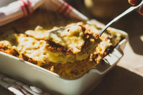 Shepherd's pie in white baking dish on the table Stock Photos