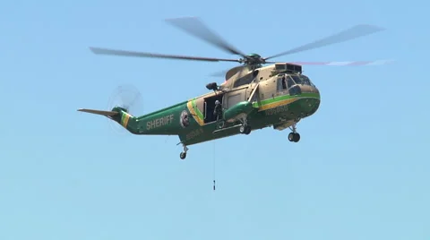 Sheriffs Rescue Heli fly in pick up guy Stock Footage 1019423
