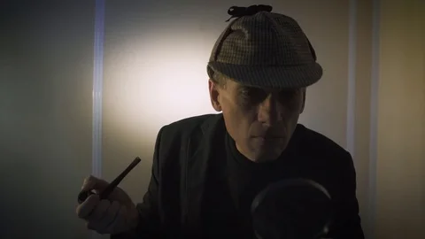 Sherlock holmes in studio detective at work with magnifying glass and pipe Stock Footage 73106619