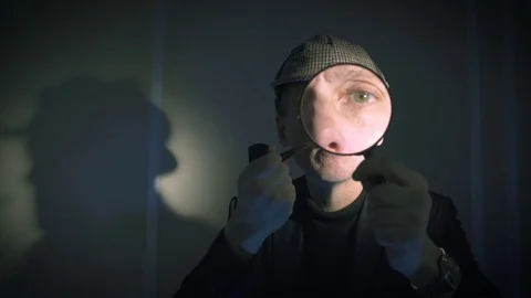 Sherlock holmes in studio detective at work with magnifying glass and pipe Stock Footage 73106647
