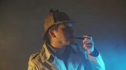 Sherlock holmes in studio etective at work with magnifying glass and pipe Stock Footage 68373121