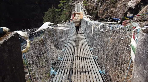 Sherpa Porter Crossing Bridge on Everest Base Camp Trek, Nepal Stock Footage