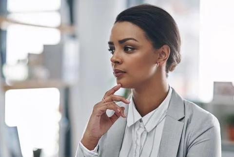 Shes always got a plan in mind. an attractive young businesswoman looking Stock Photos