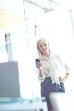 Shes always on top of her workload. Portrait of a pretty business woman texting Stock Photos