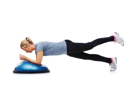 Shes determined to get into shape. A young woman working her upper body using a Stock Photos