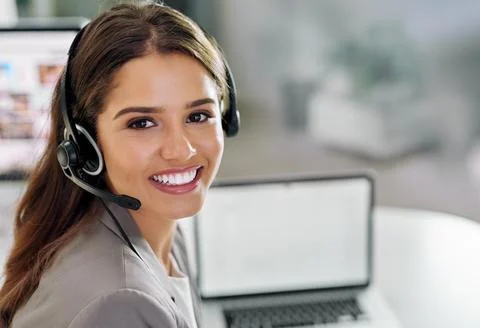 Shes the friendly face managing the helpdesk. Portrait of a young call centre Stock Photos