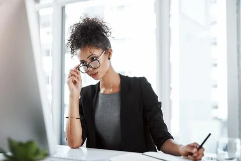 Shes got each work task covered. a young businesswoman using a computer and Stock Photos