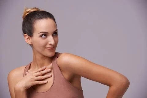 Shes got subtle con. An attractive young woman against a purple background. Stock Photos