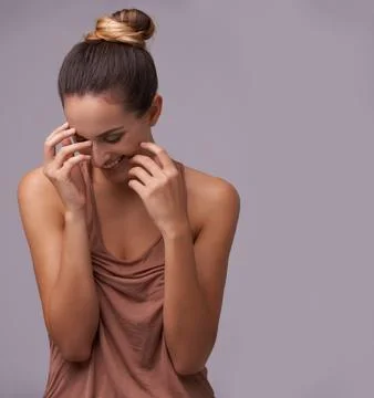 Shes got subtle con. An attractive young woman against a purple background. Stock Photos