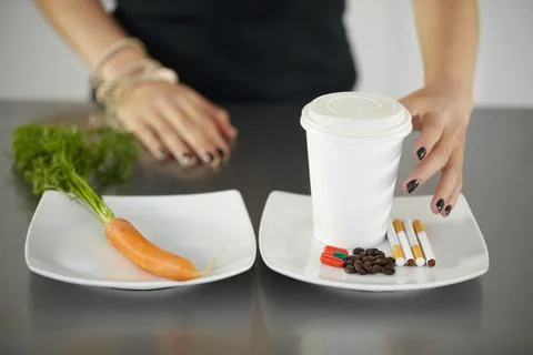 Shes making the wrong choice. A young woman choosing between healthy and Stock Photos