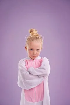 Shes one grumpy bear...A cute little blonde girl dressed as a bear while against Stock Photos