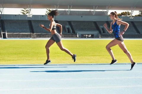 Shes setting the pace. Full length shot of two attractive young female athletes Stock Photos