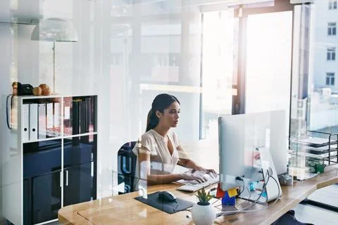 Shes very thorough in completing tasks. an attractive businesswoman working on 스톡 사진