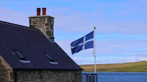Shetland Flag waving on a typical medieval house in Lerwick downtown and port in Stock Footage 248846880