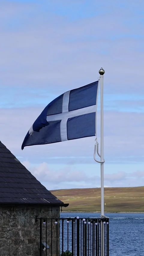 Shetland Flag waving on a typical medieval house in Lerwick downtown and port in Stock Footage 299769210