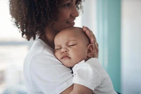 Shh, mommy is here. Shot of an adorable baby girl sleeping peacefully in her Stock Photos