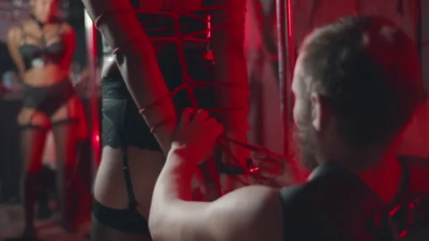 Shibari master tying rope around African-American girl hands. Realtime Stock Footage 233827282