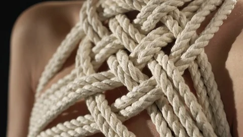 Shibari rope pattern around girl neck and breast Stock Footage 87227652