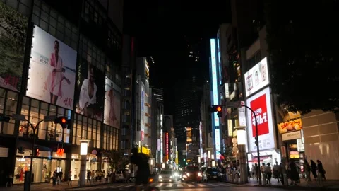 Shibuya night time streetscape with neon billboards Stock Footage