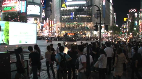  Shibuya, Tokyo, Japan. The famous crossing. People waiting. Neon signs. Traffic Stock Footage