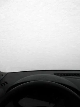 Shield of ice and snow on the windshield of the car. View from the driver's s Stock Photos