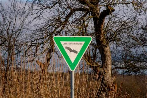 Shield with nature reserve in front of a tree Stock-Fotos