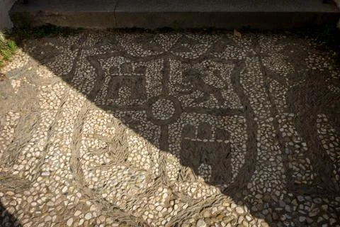 Shield patterns on a stone walking path at the Alhambra palace in Granada, Sp Stock Photos