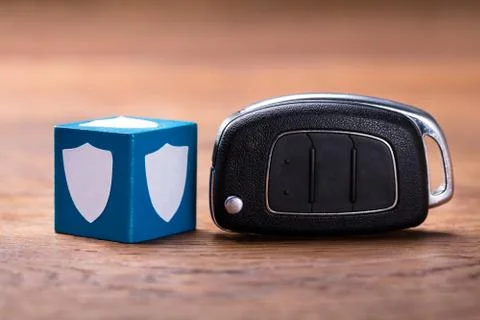 Shield Shape On Block With Car Key Fotos Stock